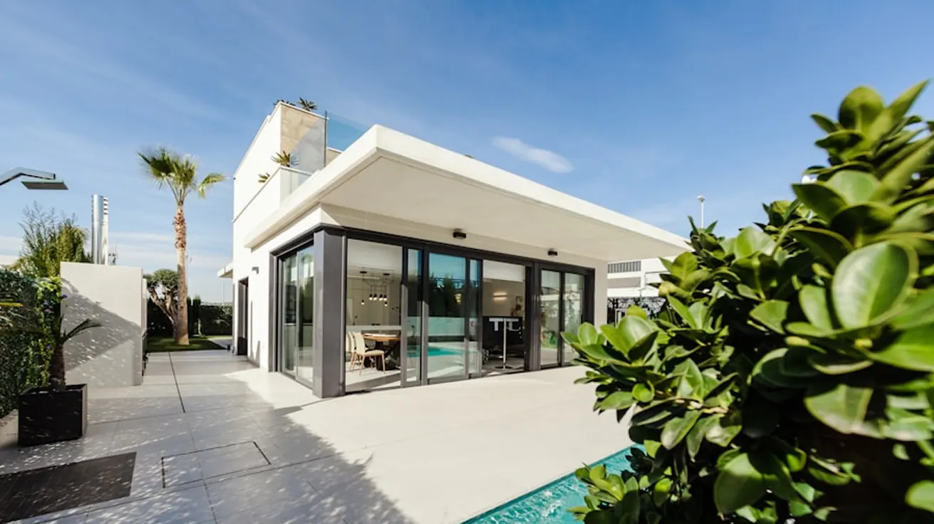 White modernist villa with a pool and garden
