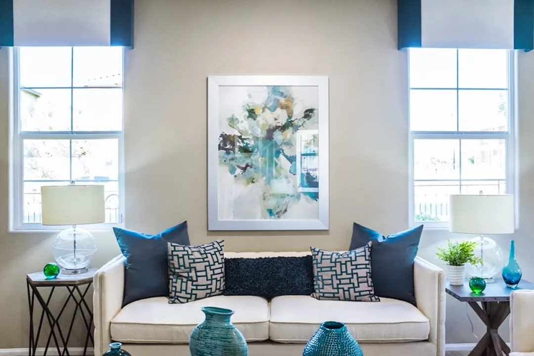 Symmetrical living room with a white sofa and blue cushions