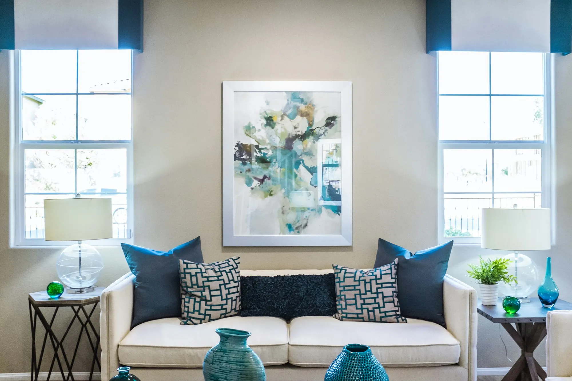 Symmetrical living room with a white sofa and blue cushions