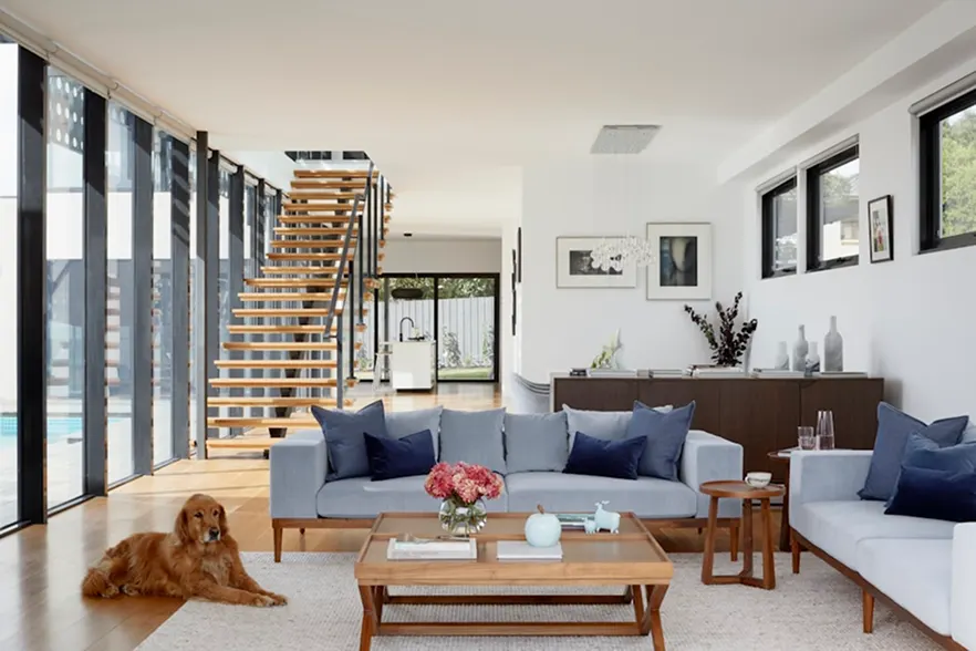 Double-height living room with an open timber stair